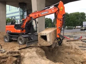 Graafmachine tilt een houten balk